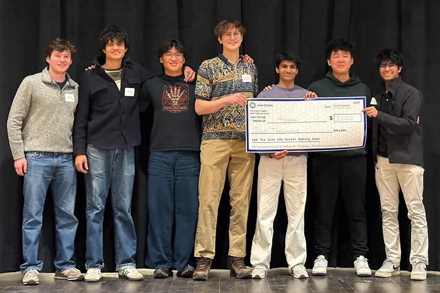 4sigma, 2026 Market Making Game champions, holding the Jane Street prize check