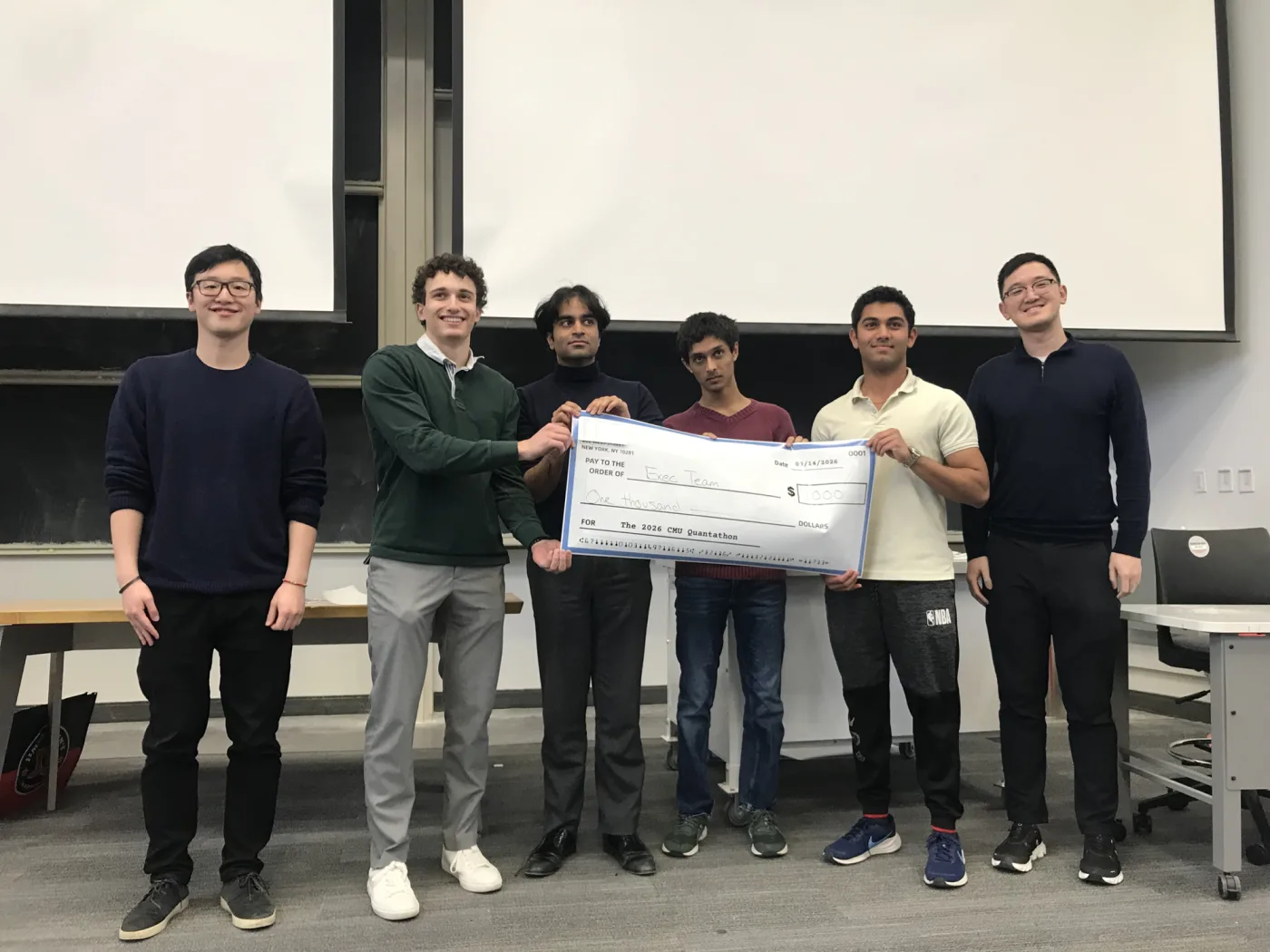 Team Exec, Quantathon 2026 runners-up, holding their prize check